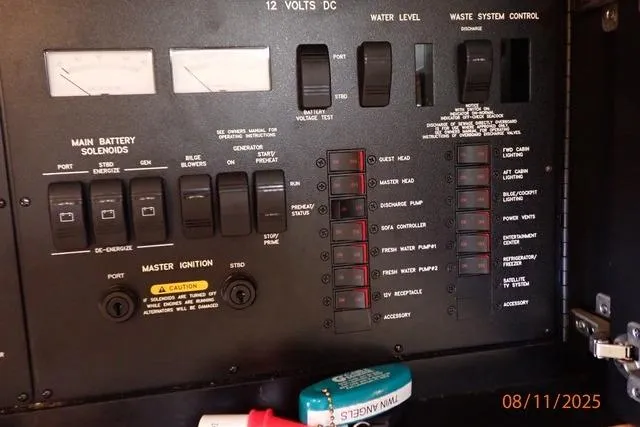 Slide: The Image of Control panel of a 2003 Sea Ray 460 Sundancer boat, showing switches and indicators. - 41