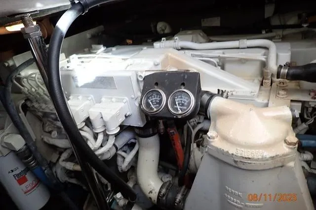 Slide: The Image of Engine compartment of 2003 Sea Ray 460 Sundancer with gauges and components visible. - 52