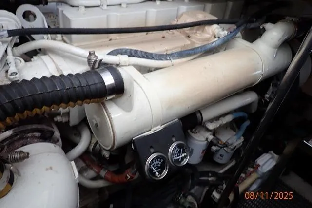Slide: The Image of Engine compartment of 2003 Sea Ray 460 Sundancer with visible gauges and hoses. - 54