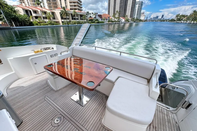 Slide: The Image of Luxurious 2012 Azimut Fly 53 yacht cruising on a scenic waterway with elegant seating area. - 11