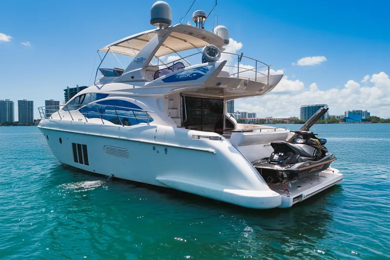 Slide: The Image of Luxury Azimut Fly 53 yacht from 2012 on clear blue water, city skyline in background. - 6