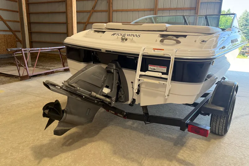 Slide: The Image of 2008 Four Winns H183FS boat on trailer in a storage facility. - 5