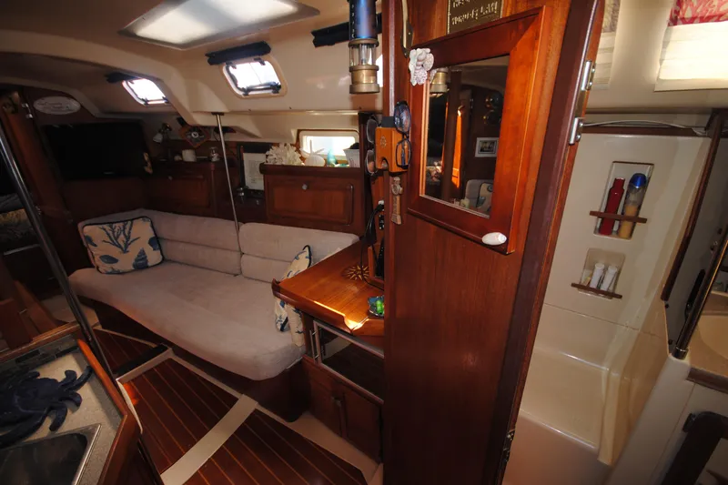 Slide: The Image of Interior of 1993 Hunter Legend 35.5 sailboat with cozy seating and wooden cabinetry. - 10