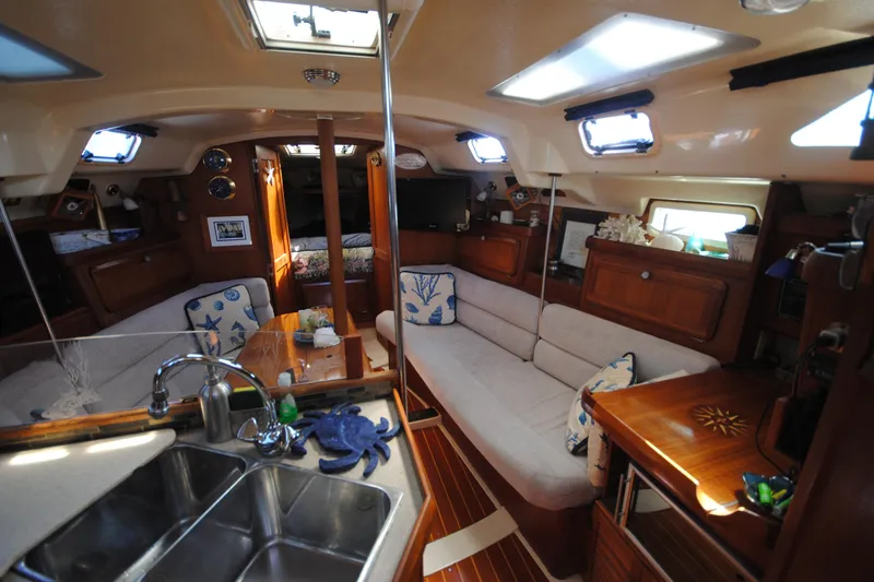 Slide: The Image of Interior of 1993 Hunter Legend 35.5 sailboat with cozy seating and wooden cabinetry. - 11
