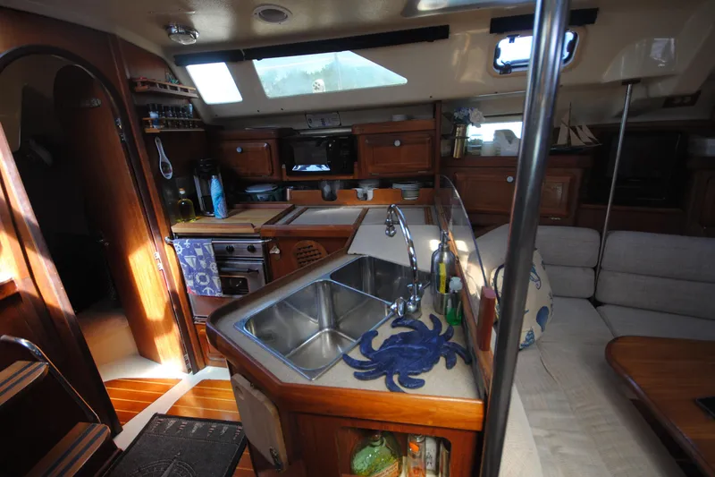Slide: The Image of Interior of 1993 Hunter Legend 35.5 sailboat with kitchen and seating area. - 13