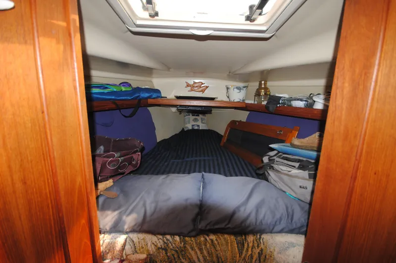 Slide: The Image of Cozy cabin interior of 1993 Hunter Legend 35.5 sailboat with bedding and storage. - 14