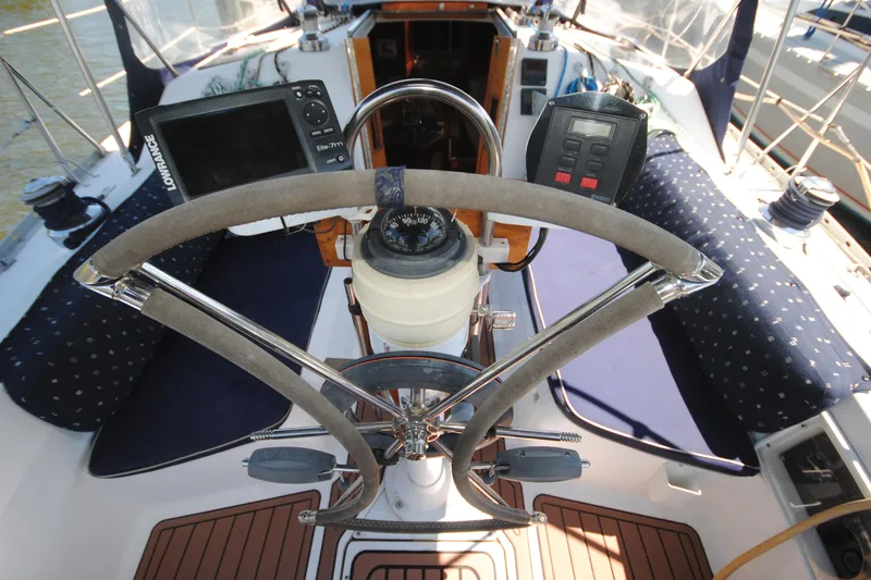 Slide: The Image of Cockpit of 1993 Hunter Legend 35.5 sailboat with navigation instruments and steering wheel. - 2