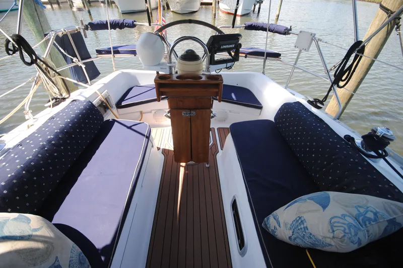 Slide: The Image of Cockpit of 1993 Hunter Legend 35.5 sailboat with blue cushions and wooden steering pedestal. - 3