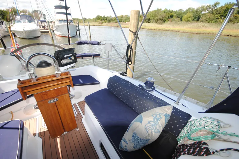 Slide: The Image of Cockpit of 1993 Hunter Legend 35.5 sailboat with blue cushions and wooden helm. - 4