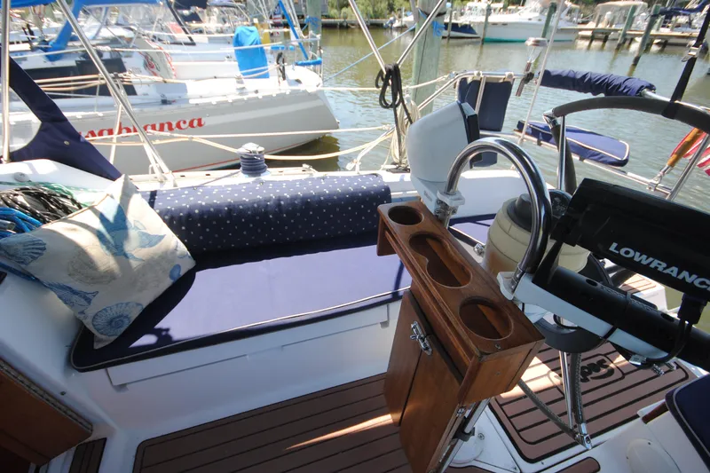 Slide: The Image of Cozy cockpit of 1993 Hunter Legend 35.5 sailboat with blue cushions and wooden cup holder. - 5