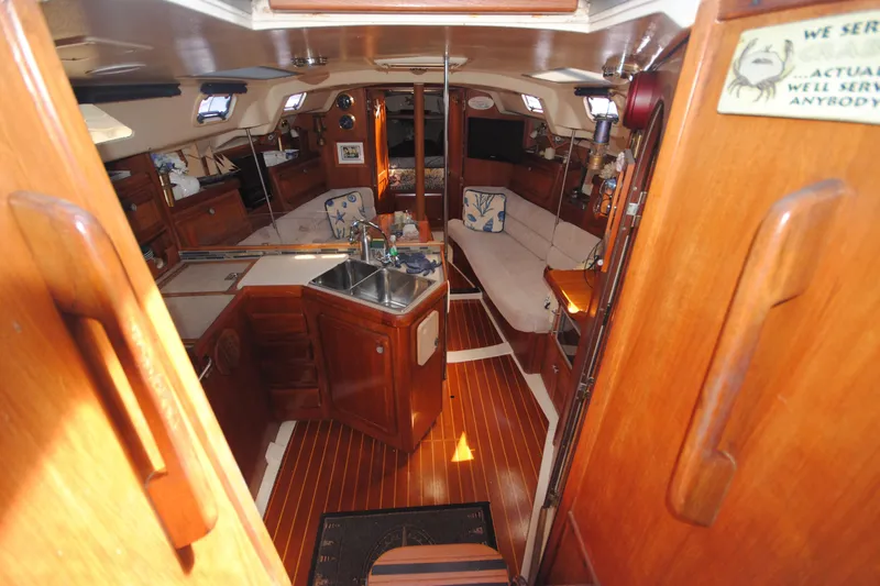 Slide: The Image of Interior of 1993 Hunter Legend 35.5 sailboat with wooden finishes and cozy seating area. - 8