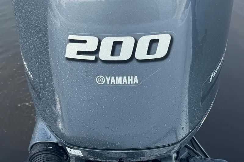 Slide: The Image of Yamaha 200 outboard motor on 2023 Edgewater 208CC boat, wet with water droplets. - 12