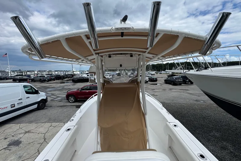 Slide: The Image of 2023 Edgewater 208CC boat with T-top, docked at marina under cloudy sky. - 16