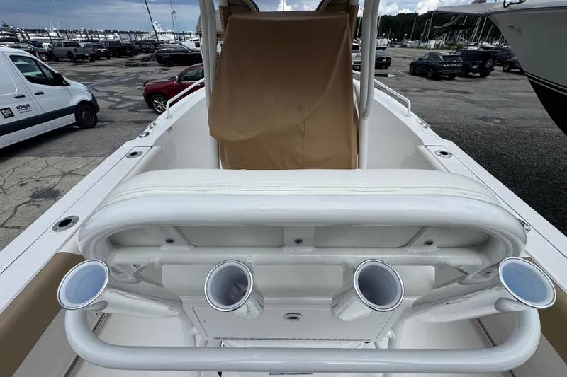 Slide: The Image of 2023 Edgewater 208CC boat interior with rod holders, docked at marina. - 17