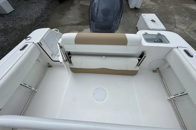 Slide: The Image of 2023 Edgewater 208CC boat interior with seating and storage compartments. - 18