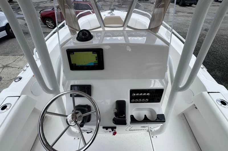 Slide: The Image of 2023 Edgewater 208CC boat console with steering wheel and navigation display. - 19