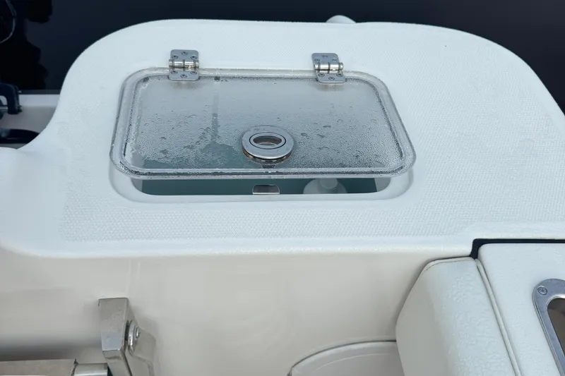 Slide: The Image of 2023 Edgewater 208CC boat livewell with a transparent lid and metal latch. - 24
