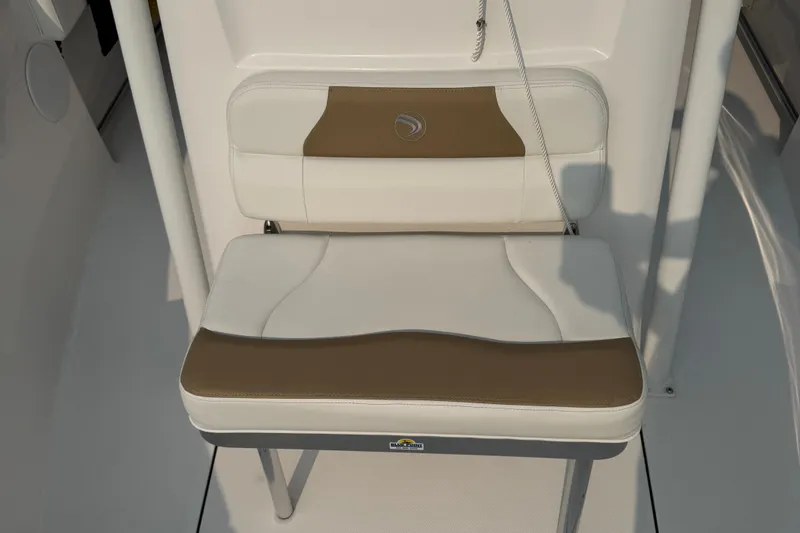 Slide: The Image of 2023 Edgewater 208CC boat seat with white and brown cushioned design. - 29