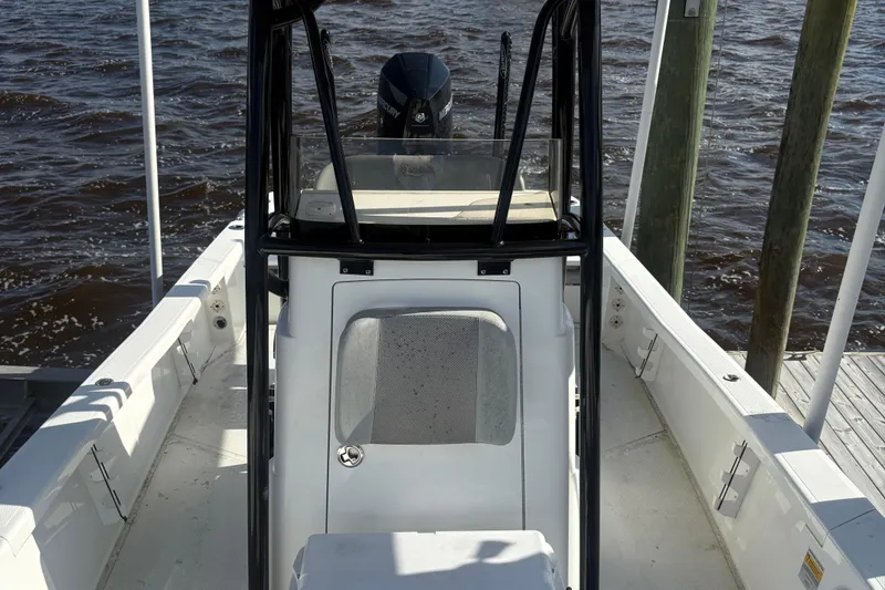 Slide: The Image of 2022 BlackJack 256 Bay boat docked, showcasing interior and motor. - 11