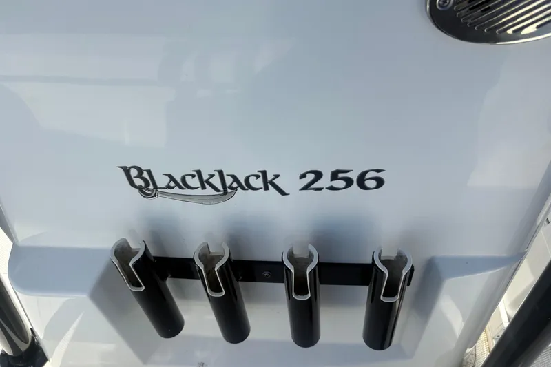 Slide: The Image of 2022 BlackJack 256 Bay boat with rod holders and sleek design. - 7