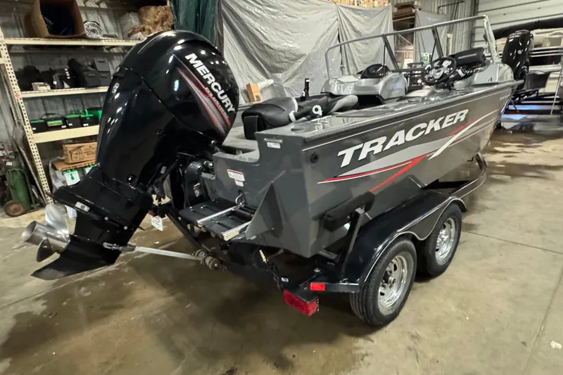 Slide: The Image of 2015 Tracker Targa V-18 Combo boat with Mercury outboard motor in a garage. - 3