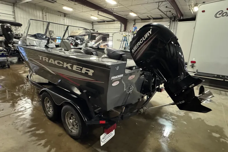 Slide: The Image of 2015 Tracker Targa V-18 Combo boat with Mercury engine in indoor storage. - 5