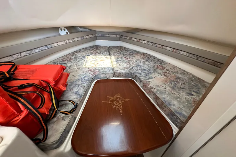 Slide: The Image of Interior cabin of 2000 Pursuit 2870 Walkaround boat with life jackets and patterned cushions. - 10