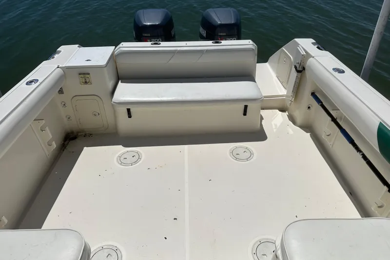 Slide: The Image of 2000 Pursuit 2870 Walkaround boat deck with seating and dual Yamaha engines. - 6