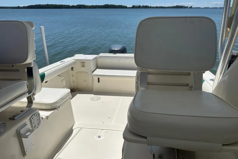 Slide: The Image of 2000 Pursuit 2870 Walkaround boat interior with seating, overlooking calm waters. - 7