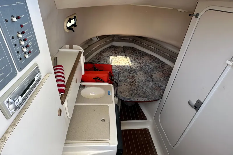 Slide: The Image of Interior of 2000 Pursuit 2870 Walkaround boat with cabin amenities and seating area. - 9
