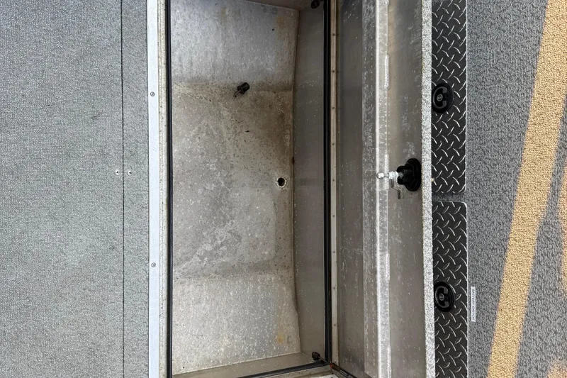 Slide: The Image of 2023 Thunder Jet 22 Alexis Pro boat storage compartment, open and empty, with metal interior. - 11