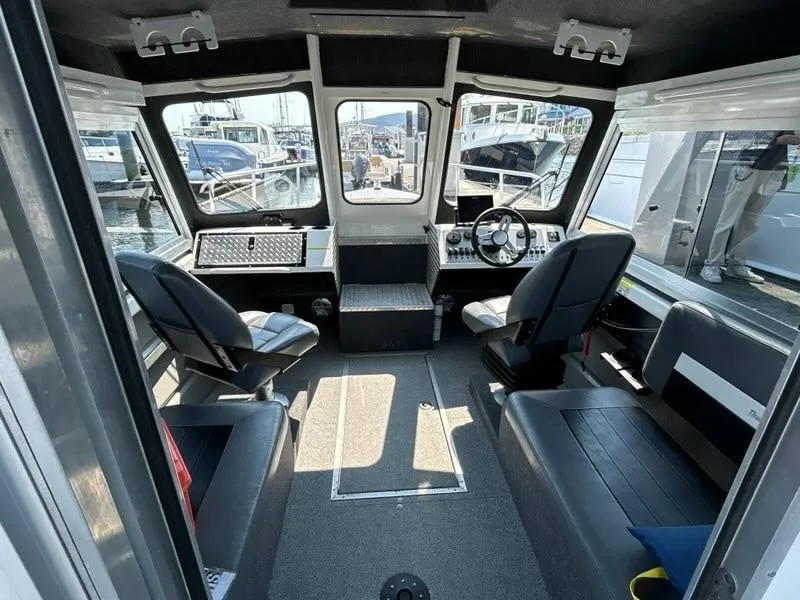 Slide: The Image of 2023 Thunder Jet 22 Alexis Pro boat docked at marina with sailboats in background. - 2