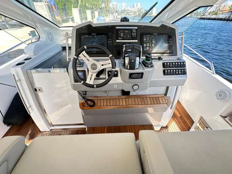 Slide: The Image of Helm of 2018 Azimut Verve 40 yacht with modern controls and wooden accents. - 18