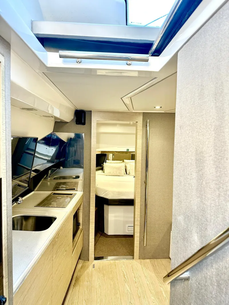 Slide: The Image of Interior of 2018 Azimut Verve 40 yacht, featuring modern kitchen and cozy sleeping area. - 28