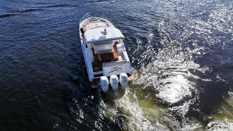 Slide: The Image of 2018 Azimut Verve 40 yacht cruising on open water, rear view. - 4