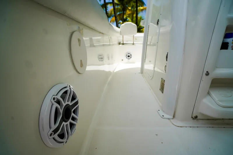 Slide: The Image of 2016 Sea Hunt Gamefish 30 boat interior with speaker and storage compartments. - 11