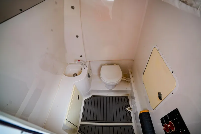 Slide: The Image of 2016 Sea Hunt Gamefish 30 boat bathroom with toilet and sink. - 12