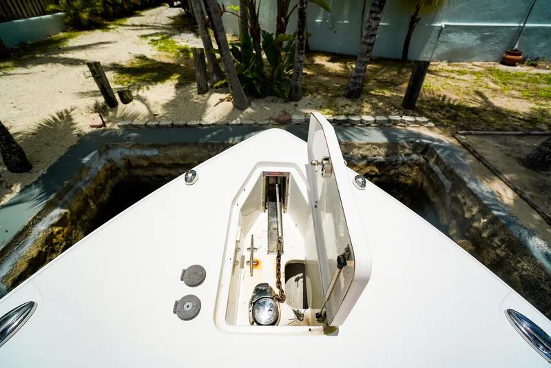 Slide: The Image of 2016 Sea Hunt Gamefish 30 boat anchor compartment, open lid, tropical setting. - 18