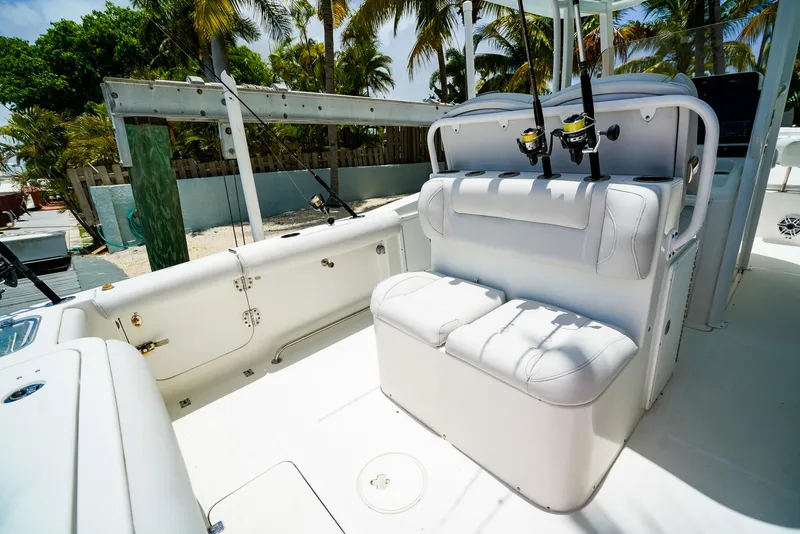 Slide: The Image of 2016 Sea Hunt Gamefish 30 boat interior with white seating and fishing rods. - 4