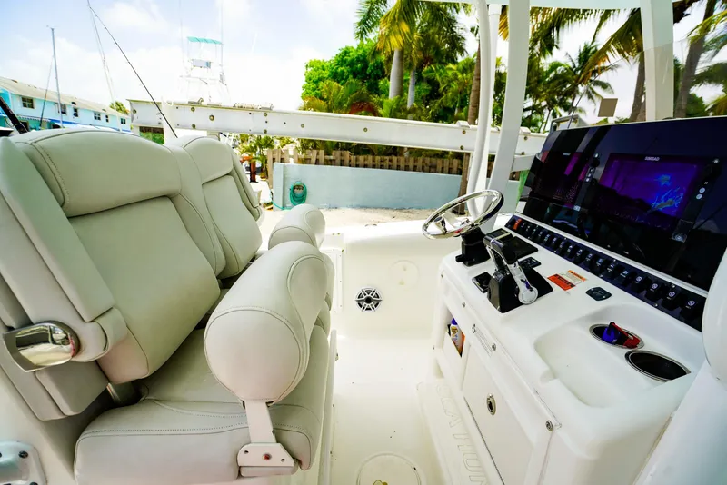 Slide: The Image of 2016 Sea Hunt Gamefish 30 boat cockpit with modern controls and comfortable seating. - 8