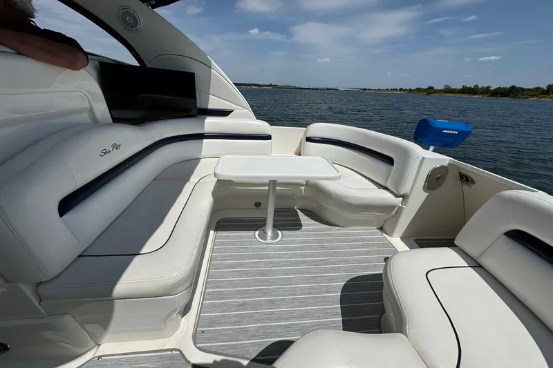 Slide: The Image of Luxurious 2010 Sea Ray 390 Sundancer yacht interior with white seating and table on a sunny day. - 21