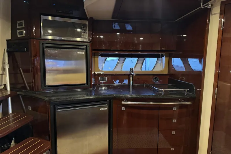 Slide: The Image of Luxurious kitchen interior of 2010 Sea Ray 390 Sundancer yacht with modern appliances. - 23