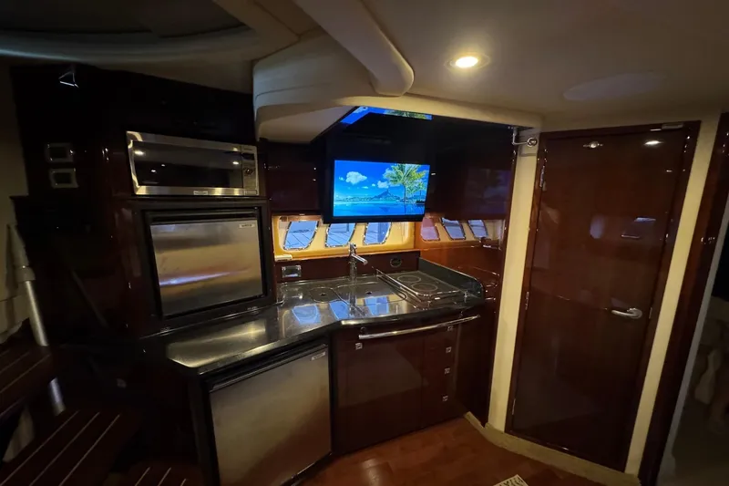 Slide: The Image of Luxurious interior of 2010 Sea Ray 390 Sundancer yacht with modern kitchen amenities. - 24
