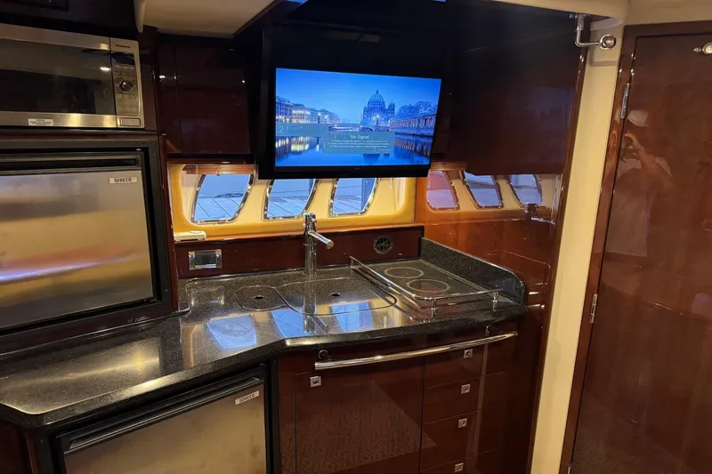 Slide: The Image of Luxurious kitchen interior of 2010 Sea Ray 390 Sundancer yacht with modern appliances. - 25