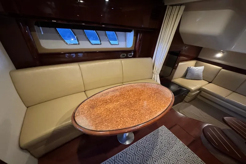 Slide: The Image of Luxurious interior of 2010 Sea Ray 390 Sundancer yacht with elegant seating and table. - 26