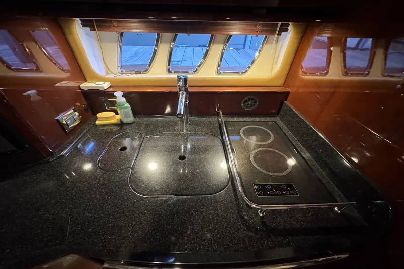 Slide: The Image of Luxurious kitchen area in 2010 Sea Ray 390 Sundancer yacht with sleek countertops. - 27