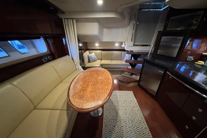 Slide: The Image of Luxurious interior of 2010 Sea Ray 390 Sundancer yacht with elegant seating and modern kitchen. - 29