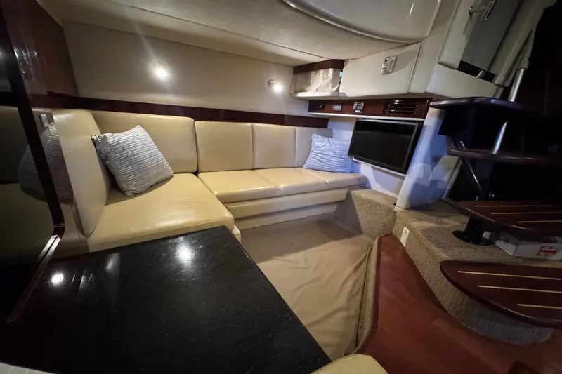 Slide: The Image of Interior of 2010 Sea Ray 390 Sundancer yacht with beige seating and modern amenities. - 30