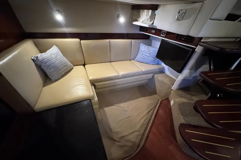 Slide: The Image of Luxurious interior of 2010 Sea Ray 390 Sundancer with beige seating and modern amenities. - 31