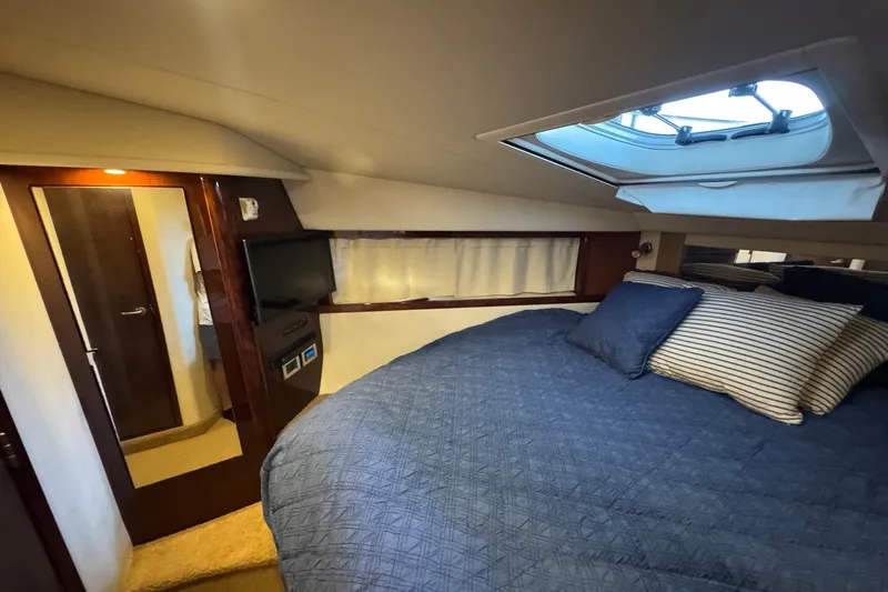Slide: The Image of Luxurious cabin interior of 2010 Sea Ray 390 Sundancer with skylight and cozy bedding. - 33